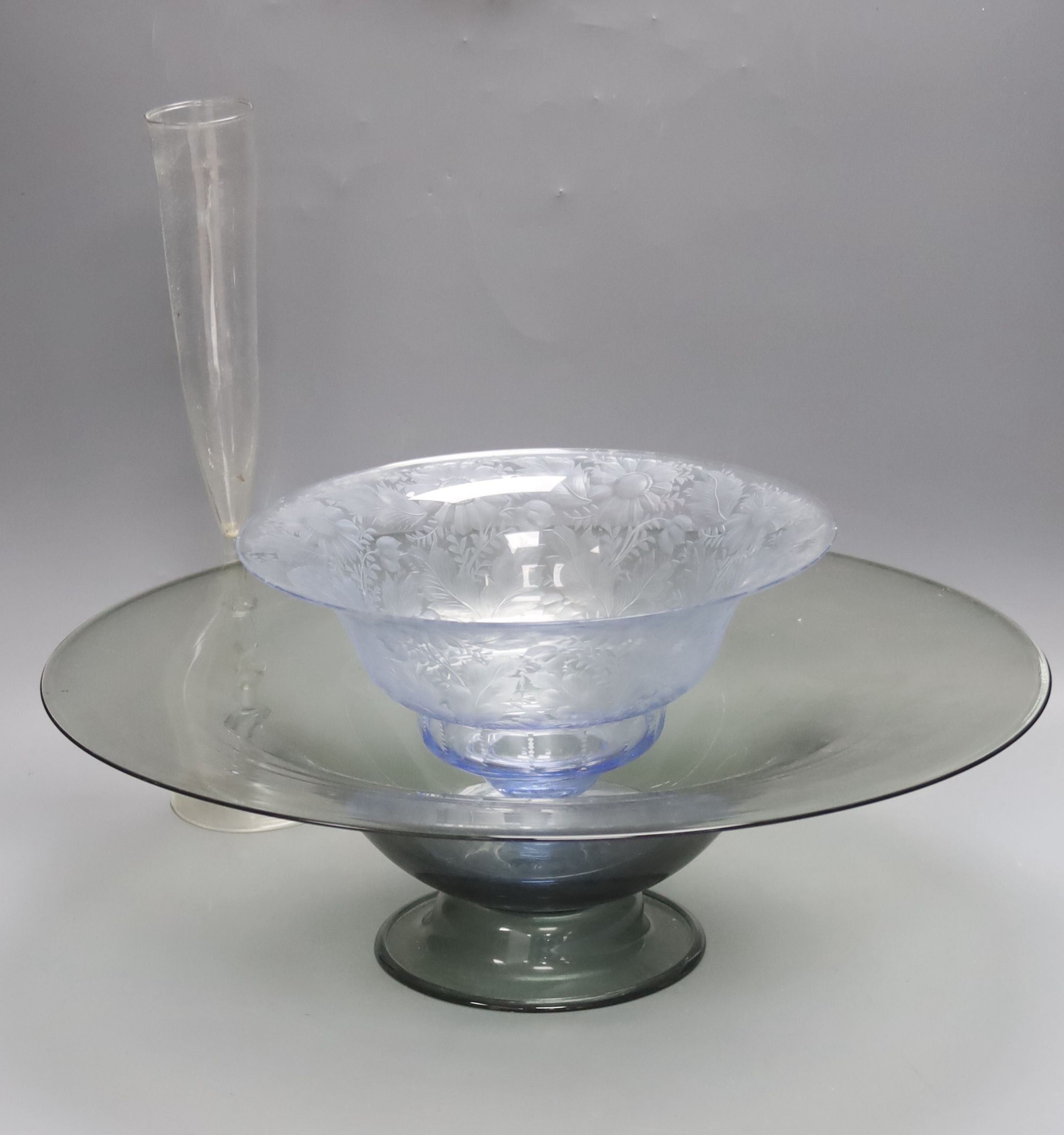 A Dutch Venetian style tall glass flute, the twisted stem with blue bead decoration, H 38cm, a 'Facon-de-Venise' style blue-tinted pedestal bowl, foliate-engraved and another glass dish (3)